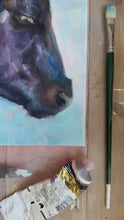 Load and play video in Gallery viewer, Video in art studio of original oil painting by Leigh Pritchard - Leigh Suzie Art of black angus cow with a blue background.